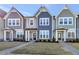 Three gray and blue townhomes with small front yards and sidewalks at 3181 Mission Olive Pl # 346, New Hill, NC 27562
