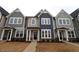 Three-story townhouses with gray and navy siding, and landscaping at 3181 Mission Olive Pl # 346, New Hill, NC 27562