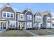 Three newly constructed townhomes with varying shades of gray and blue siding, small front yards, and sidewalks at 3181 Mission Olive Pl # 346, New Hill, NC 27562