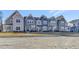 Row of attractive townhomes featuring modern designs, tidy landscaping, and inviting curb appeal at 3181 Mission Olive Pl # 346, New Hill, NC 27562