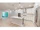 Modern, open kitchen with white cabinets, stainless steel appliances, and a large island at 3181 Mission Olive Pl # 346, New Hill, NC 27562