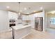 Bright, modern kitchen with white cabinetry, stainless appliances, and an island with pendant lighting at 3181 Mission Olive Pl # 346, New Hill, NC 27562