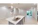 Kitchen island with a stainless steel sink, modern faucet and stylish pendant lighting at 3181 Mission Olive Pl # 346, New Hill, NC 27562