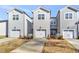 Rear view of townhomes featuring attached garages at 3181 Mission Olive Pl # 346, New Hill, NC 27562