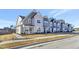 Charming street view of newly constructed townhomes with manicured lawns and sidewalks at 3181 Mission Olive Pl # 346, New Hill, NC 27562