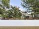 White vinyl fence encloses backyard with view of home and trees at 3716 Massey Ridge Ct, Raleigh, NC 27616