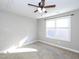 Bright bedroom with ceiling fan, carpet, and large window at 3716 Massey Ridge Ct, Raleigh, NC 27616