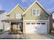 Two-story house with green and beige siding, white garage door, and landscaping at 3716 Massey Ridge Ct, Raleigh, NC 27616