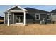 View of the backyard with sliding glass doors opening to the home's covered patio and the air conditioning unit at 222 Chestnut Oak Ln, Lillington, NC 27546