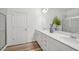 Elegant bathroom featuring double sinks, white cabinetry, quartz countertops, and a glass-enclosed shower at 222 Chestnut Oak Ln, Lillington, NC 27546