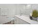 Bathroom featuring a vanity with modern fixtures, toilet, large mirror and decorative plants creating a soothing ambiance at 222 Chestnut Oak Ln, Lillington, NC 27546