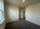 Comfortable bedroom offering a closet, a window, and neutral carpeting for versatile styling at 222 Chestnut Oak Ln, Lillington, NC 27546