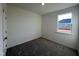 Bedroom featuring a window letting in natural light, complemented by neutral carpeting at 222 Chestnut Oak Ln, Lillington, NC 27546