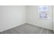 This is a bedroom with gray carpeting and a window still covered in protective film at 222 Chestnut Oak Ln, Lillington, NC 27546