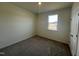 Cozy bedroom with natural light from a window, complemented by neutral walls and carpet at 222 Chestnut Oak Ln, Lillington, NC 27546