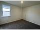 Bright, carpeted bedroom featuring a window, neutral walls, and an interior door at 222 Chestnut Oak Ln, Lillington, NC 27546