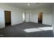 Bright bedroom featuring plush gray carpeting, a walk-in closet, and an en suite bathroom for added convenience at 222 Chestnut Oak Ln, Lillington, NC 27546