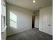 Sunny bedroom showcasing neutral walls, plush carpet, a closet and a window at 222 Chestnut Oak Ln, Lillington, NC 27546