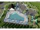 Aerial view of the community pool, playground, and parking area surrounded by lush landscaping and mature trees at 222 Chestnut Oak Ln, Lillington, NC 27546