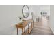 Bright entryway featuring a wooden console table with decorative accents, leading into an open-concept living space at 222 Chestnut Oak Ln, Lillington, NC 27546
