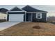 New construction home with gray siding, white garage door, and landscaping at 222 Chestnut Oak Ln, Lillington, NC 27546
