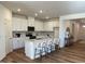 Bright kitchen with stainless steel appliances, white cabinets, an island and seating, enhancing style and functionality at 222 Chestnut Oak Ln, Lillington, NC 27546