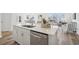 Spacious kitchen island with a stainless steel dishwasher, sink, and views into the living room at 222 Chestnut Oak Ln, Lillington, NC 27546