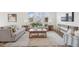 Inviting living room with neutral tones, comfortable seating, a rustic coffee table, and abundant natural light at 222 Chestnut Oak Ln, Lillington, NC 27546