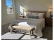Inviting main bedroom showcasing a cozy bed with side tables and a charming wooden bench at 222 Chestnut Oak Ln, Lillington, NC 27546