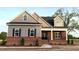 New home featuring mixed materials, dormers, and inviting front porch at 1681 S Old Carriage Rd, Rocky Mount, NC 27804