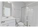 Bright bathroom featuring a glass-enclosed shower, a white vanity with chrome fixtures, and a toilet at 2038 Fishamble St, Fuquay Varina, NC 27526