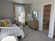 Bright bedroom featuring a twin bed, soft carpet, and an ensuite bathroom at 2038 Fishamble St, Fuquay Varina, NC 27526