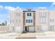 Modern three-story townhome with brick and siding, featuring an attached garage and well-maintained landscaping at 2038 Fishamble St, Fuquay Varina, NC 27526