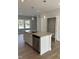 Modern kitchen island with granite countertops, stainless steel appliances, and pendant lighting at 2038 Fishamble St, Fuquay Varina, NC 27526