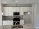 Modern kitchen showcasing stainless steel appliances and stylish pendant lighting at 2038 Fishamble St, Fuquay Varina, NC 27526