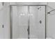 Modern shower with glass doors, a rainfall showerhead, and white subway tiles at 2038 Fishamble St, Fuquay Varina, NC 27526