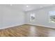 Bright bedroom with wood-look flooring and windows providing natural light at 2042 Fishamble St # 32, Fuquay Varina, NC 27526