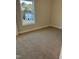 Cozy bedroom featuring neutral carpeting and a bright window offering natural light at 2042 Fishamble St, Fuquay Varina, NC 27526