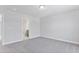 Spacious carpeted bedroom with ensuite bathroom featuring neutral walls and ample natural light at 2042 Fishamble St # 32, Fuquay Varina, NC 27526