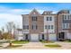 Modern townhouse with brick and gray siding, featuring a two-car garage and manicured lawn at 2042 Fishamble St # 32, Fuquay Varina, NC 27526