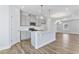 Open-concept kitchen featuring gray cabinets, a center island, and wood-look flooring at 2042 Fishamble St # 32, Fuquay Varina, NC 27526