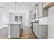 Kitchen with island, stainless steel appliances, gray cabinets and pendant lighting at 2042 Fishamble St # 32, Fuquay Varina, NC 27526