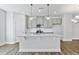 Modern kitchen with gray cabinets, quartz countertops, and a large kitchen island at 2042 Fishamble St # 32, Fuquay Varina, NC 27526