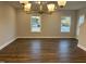 Spacious living room features hardwood floors, a modern chandelier, and lots of natural light at 2042 Fishamble St, Fuquay Varina, NC 27526