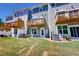 Townhome backyards feature wooden decks, patios, green grass, and A/C units at 2337 Bay Minette Sta # 553, Apex, NC 27502