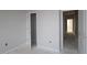 Unfinished bedroom featuring two entryways, an outlet, and a closet at 2337 Bay Minette Sta # 553, Apex, NC 27502