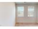 Neutral bedroom with neutral carpet, neutral walls, and two windows with natural light at 2337 Bay Minette Sta # 553, Apex, NC 27502