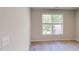 Neutral bedroom with neutral walls and carpet, featuring a window with natural light at 2337 Bay Minette Sta # 553, Apex, NC 27502
