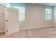 Inviting bedroom with neutral walls, carpet, and two windows with horizontal blinds for natural light at 2337 Bay Minette Sta # 553, Apex, NC 27502