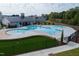 Aerial view of the community pool with seating, umbrellas, and lounge chairs at 2337 Bay Minette Sta # 553, Apex, NC 27502